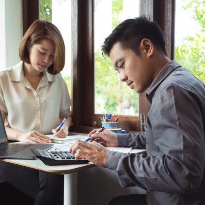 asian-man-is-calculating-business-expenses-with-mate_46139-1278