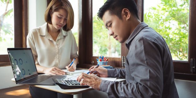 asian-man-is-calculating-business-expenses-with-mate_46139-1278