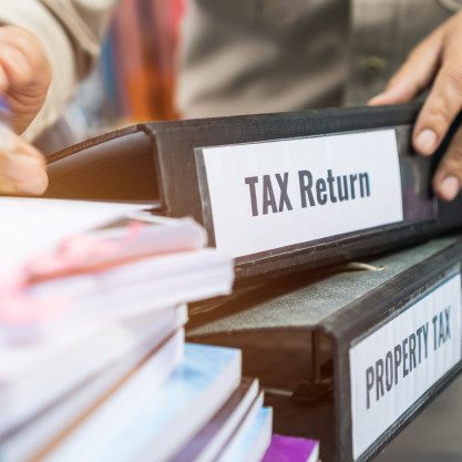 tax-return-property-tax-folders-stack-with-label-black-binder-paperwork-document-summary-report_4236-1321