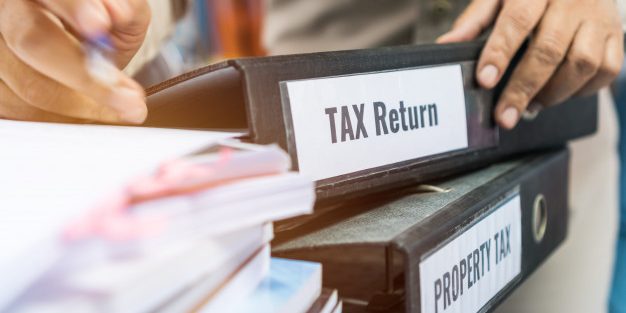 tax-return-property-tax-folders-stack-with-label-black-binder-paperwork-document-summary-report_4236-1321