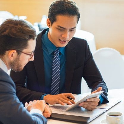 two-content-business-partners-discussing-issue_1262-3663