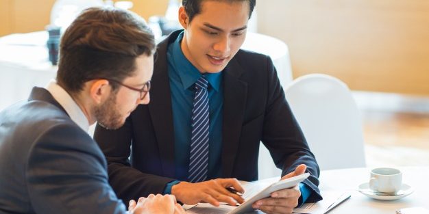 two-content-business-partners-discussing-issue_1262-3663