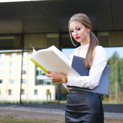 young-business-woman-with-displeased-facial-expression-examines-documents-detail_153608-15