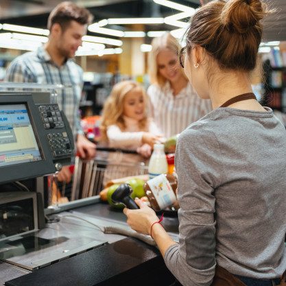beautiful-family-standing-cash-counter_171337-2410