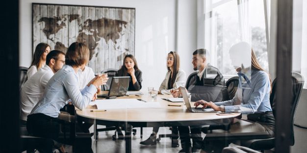group-people-working-out-business-plan-office_1303-15773
