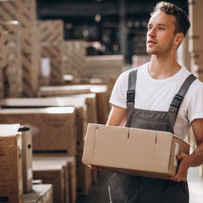 young-man-working-warehouse-with-boxes_1303-16606