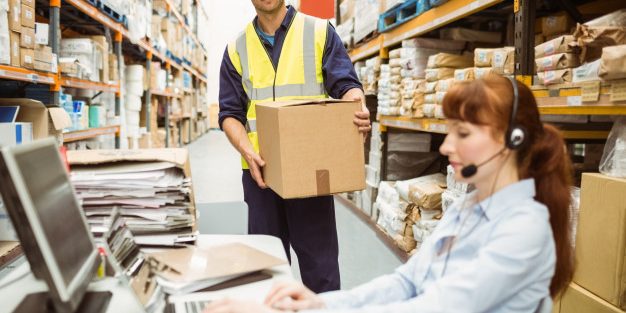 warehouse-manager-wearing-headset-using-laptop_13339-285036