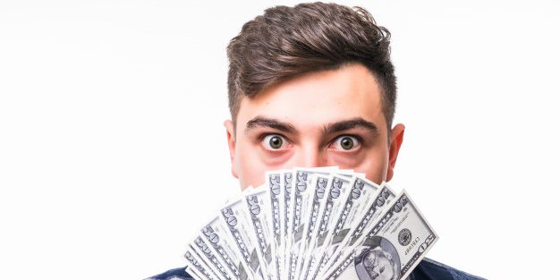 face-young-rich-man-covered-with-fan-money_231208-2294