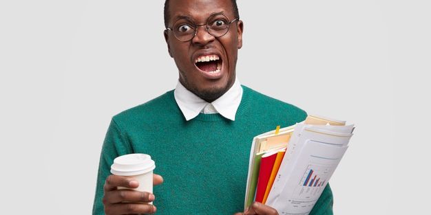 annoyed-dark-skinned-male-frowns-face-doesnt-want-study-economy-market-money-tax-being-investment-consultant-analyzes-company-annual-report_273609-24667