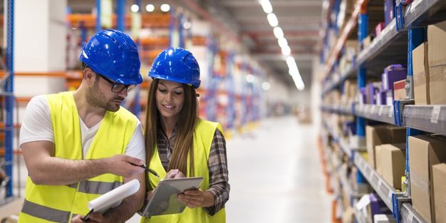 warehouse-workers-checking-inventory-consulting-each-other-about-organization-distribution-goods_342744-1539