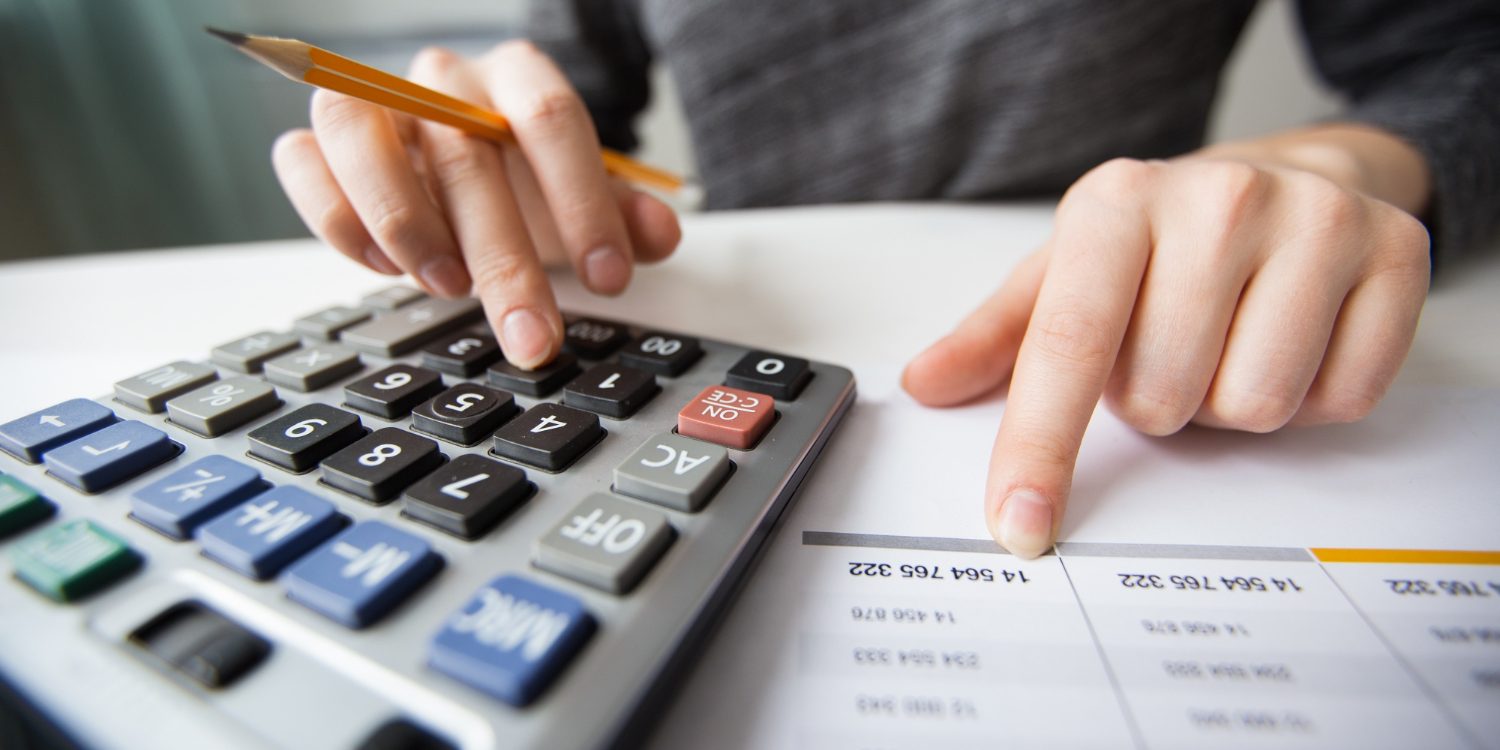 closeup-accountant-hands-counting-calculator